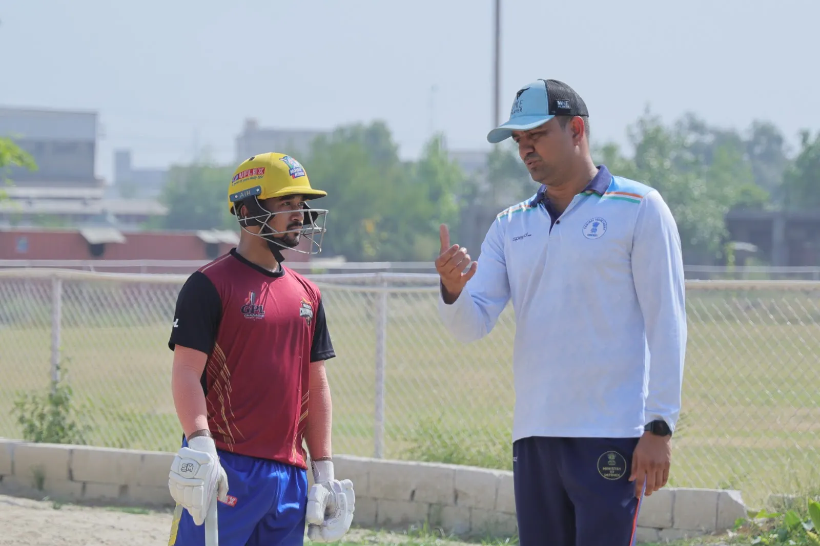 Coach mentoring a GPL batsman during net practice at HLM campus ground